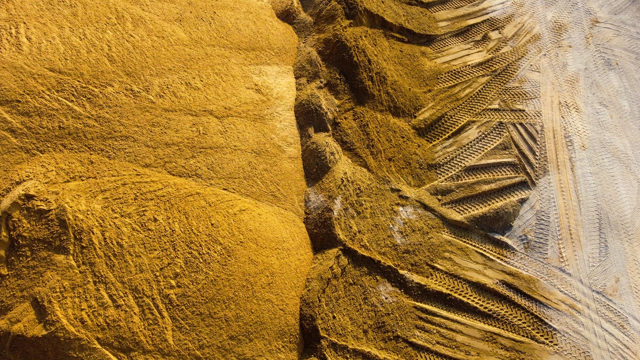 Top view of sand mounds with tire tracks in Ashdod, Israel.