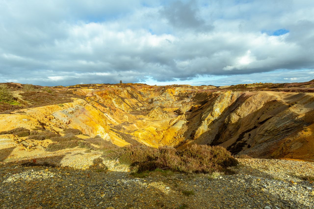 Explore the colorful terrain of Parys Mountain in Anglesey, Wales.